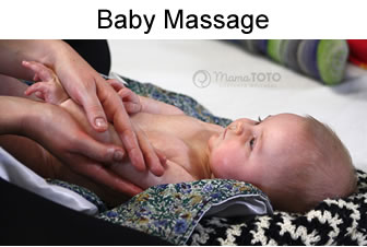 Mother massaging her baby